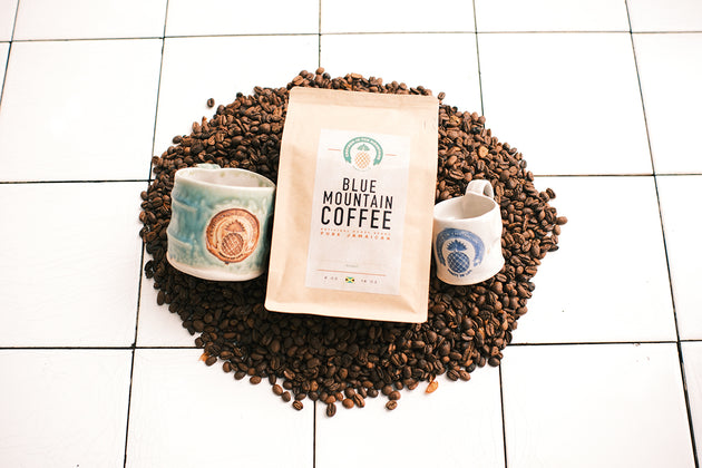 Blue Mountain Coffee package with coffee beans and mugs on a tiled floor. Best coffee beans top selling coffee beans, birthday gift for college, top quality coffee, fresh coffee beans, best coffee gift, Jamaica Blue Mountain coffee, single estate, coffee beans, organic coffee, coffee lovers, purist coffee, mother day gift for mom, birthday gift 2025, best coffee beans, father day gift 2026, coffee gift ideas, gift ideas, gift for coffee lovers, organic coffee beans, great birthday gift, best gift ideas, Chr